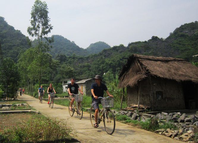 Travelers cycling through Viet Hai Village on Cat Ba Island