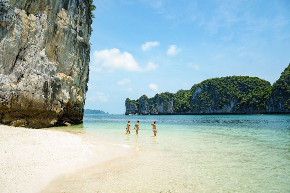 Travelers swimming at Ba Trai Dao Beach in Lan Ha Bay